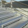 After renovation (new full fence enclosure panels, all new aluminum plank, added risers) picture of a 20 row high, 150' long bleacher seating 1,800 at Winnacunnet HS in Hampton, NH